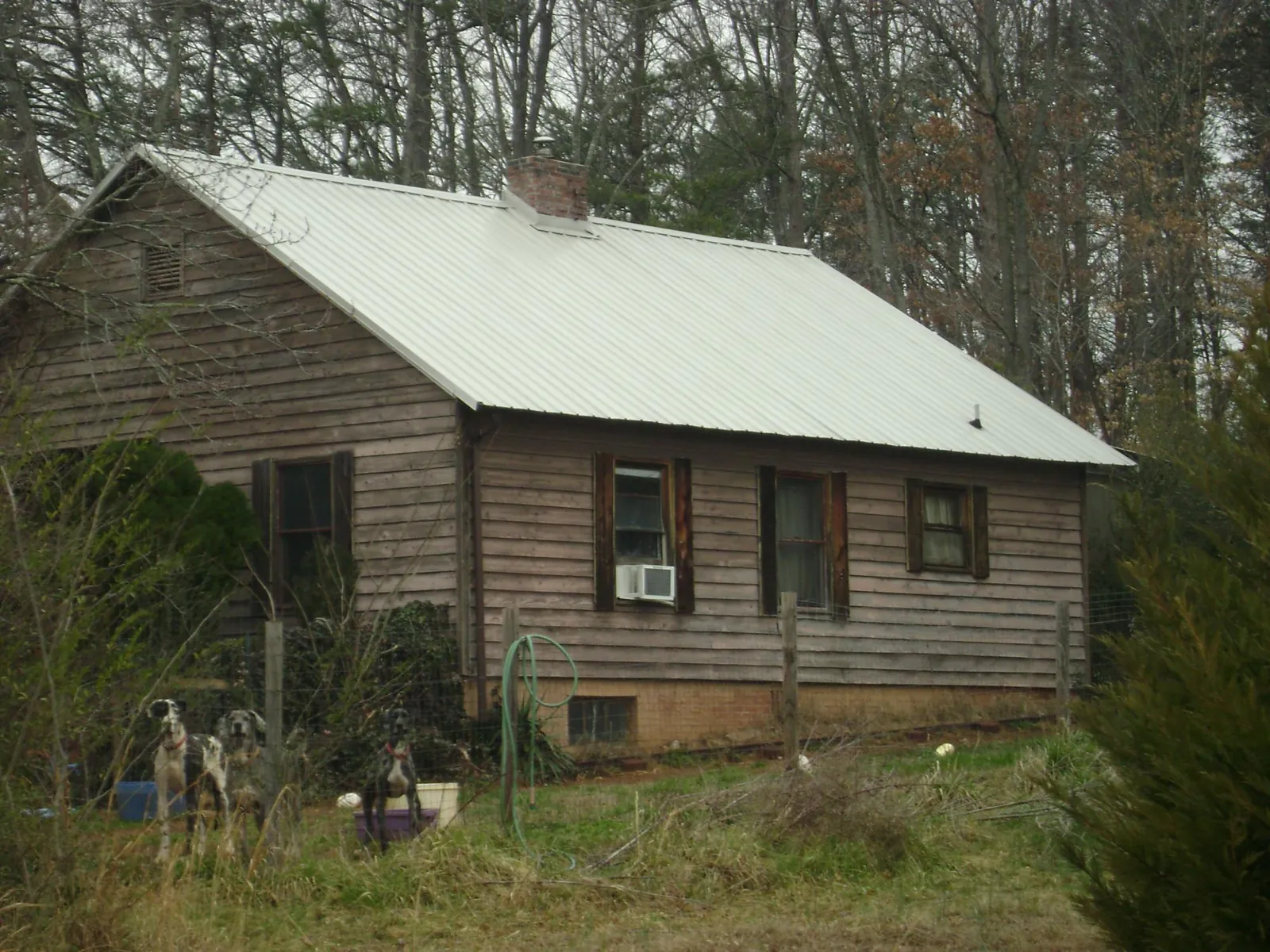 White metal roof on an old wood sided farmhouse, from a Metal Roof Installation job in South Elgin